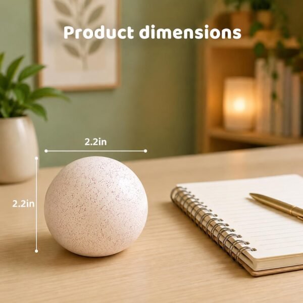 Soft pink NeeDoh Snowball sitting on a desk — Image 6 of 6