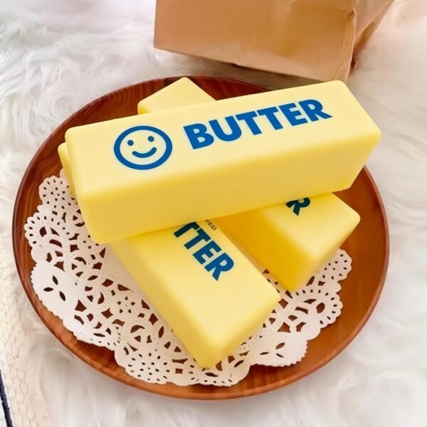 Hand holding a NeeDoh Butter Squishy realistic slow-rise butter stick toy — Image 9 of 11