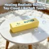 Hand holding a NeeDoh Butter Squishy realistic slow-rise butter stick toy — Image 6 of 11